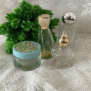 Set of 4 Vintage Perfume Bottles. 1 has a bit of perfume. Nice for display.